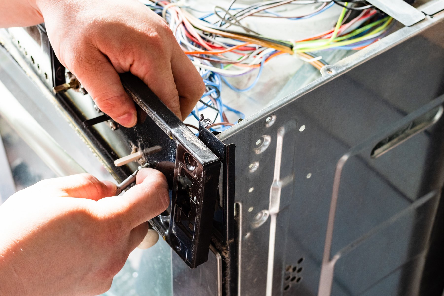 Repairman Assembles Electric Stove during Repair